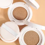 Makeup puff gently pressing onto the complexion
