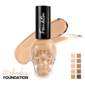 Smooth liquid complexion formula displayed beside a clear skull-shaped foundation bottle Beige facial foundation in an artistic transparent bottle with distinctive packaging