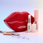 Glossy lip color included in a three piece makeup collection