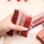 Lip gloss layered over lipstick for a glossy lip look