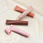 Lip gloss combined with everyday lipstick for added shine