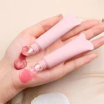 Glossy lip makeup in a squeezable cosmetic package