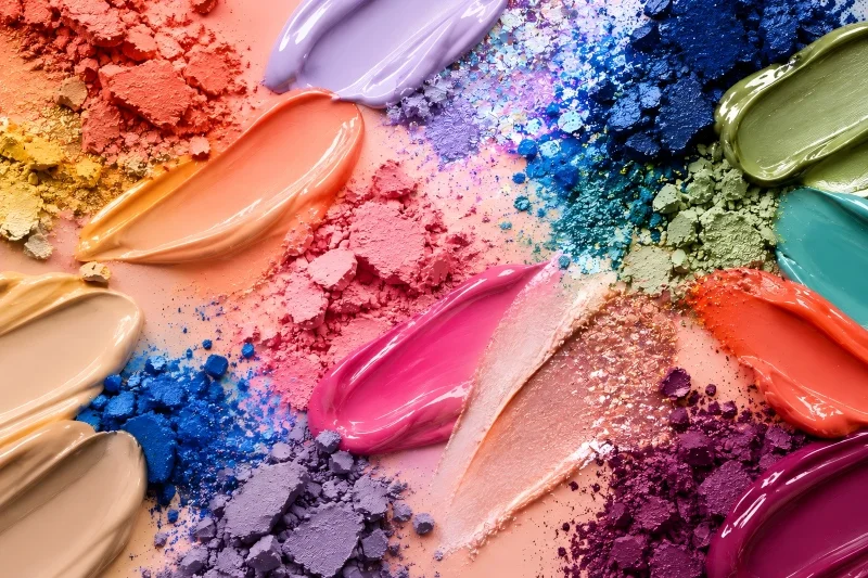 Multicolored eye makeup textures with iridescent shimmer, crushed pigments, and smooth cosmetic swatches.